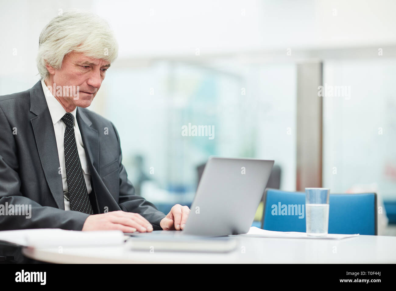 Senior Businessman Using Laptop Stock Photo