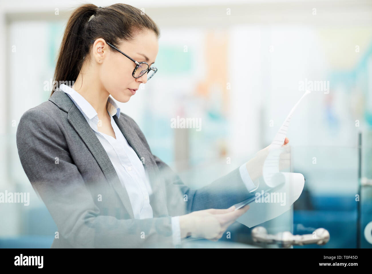 Businesswoman Reading Document Stock Photo
