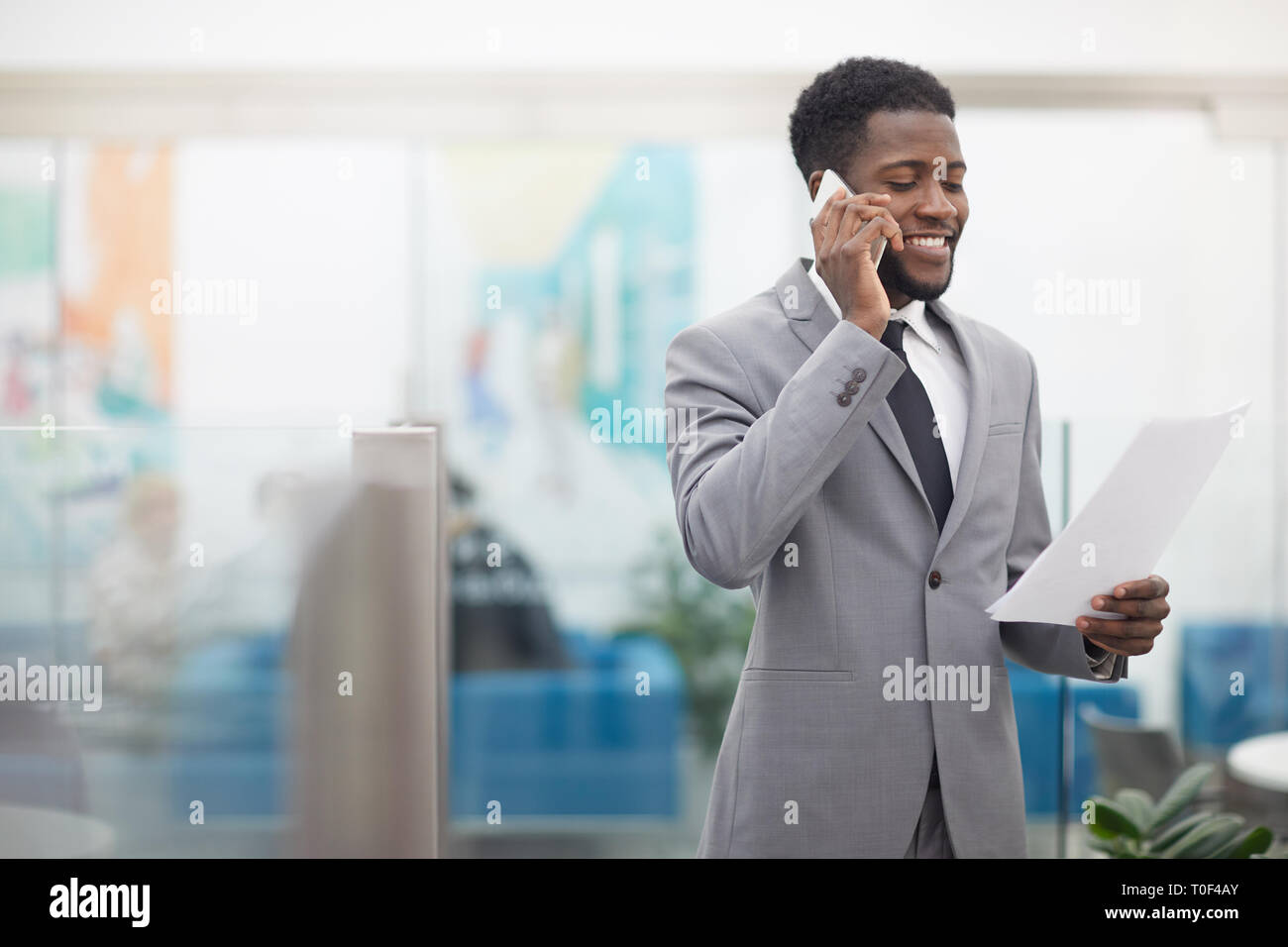 African Businessman Speaking by Phone Stock Photo