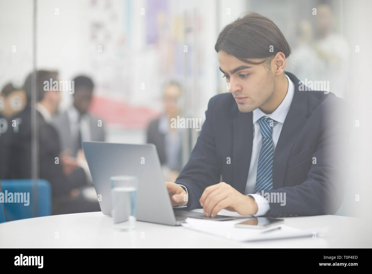 Middle-eastern Businessman using Laptop Stock Photo