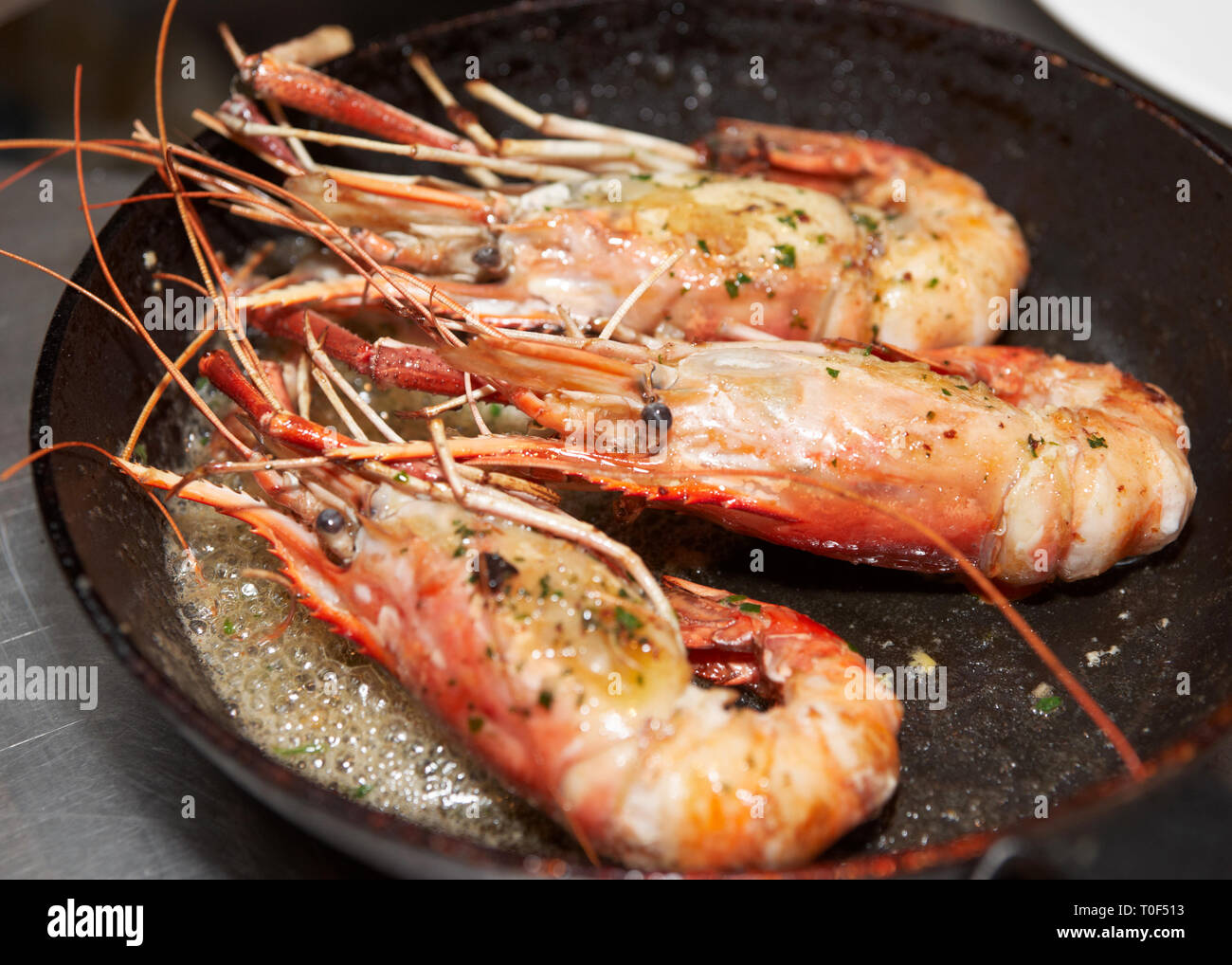 Giant prawns on hot pan stir fried in butter Stock Photo Alamy