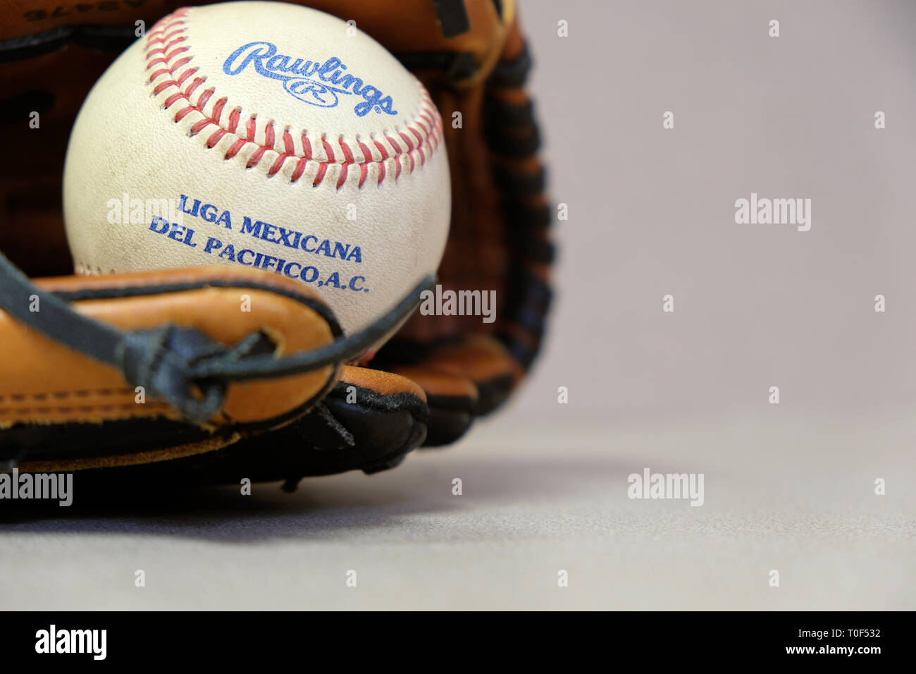 Game ball caught at a Mexican winter league game; Liga Mexicana del  Pacifico; baseball and glove Stock Photo - Alamy