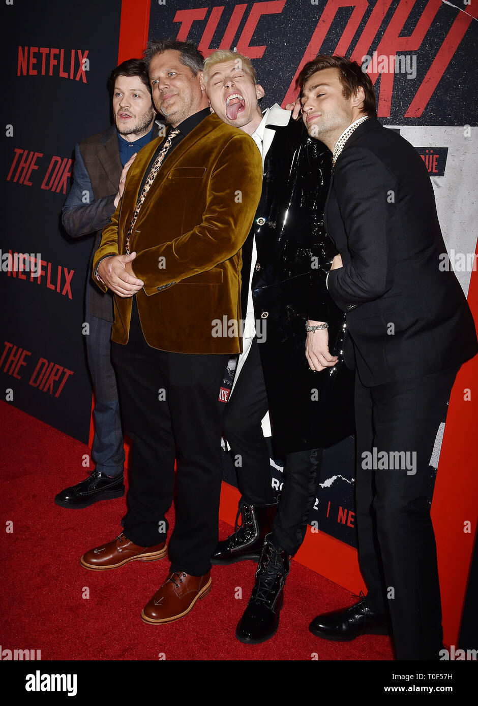 HOLLYWOOD, CA - MARCH 18: (L-R) Iwan Rheon, Jeff Tremaine, Colson Baker and Douglas Booth arrive at the Premiere Of Netflix's 'The Dirt' at ArcLight Hollywood on March 18, 2019 in Hollywood, California. Stock Photo