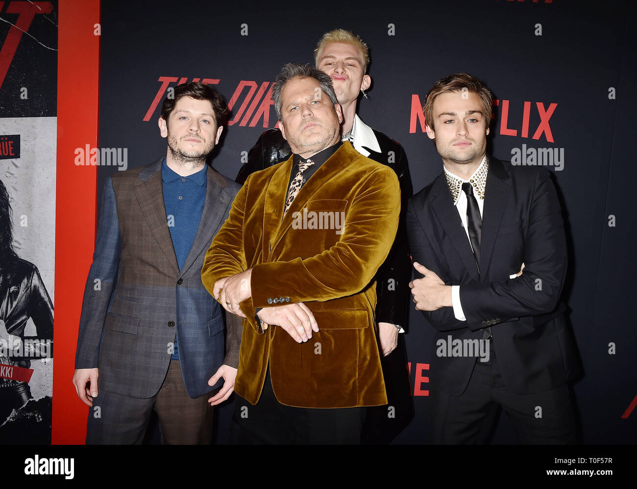 HOLLYWOOD, CA - MARCH 18: (L-R) Iwan Rheon, Jeff Tremaine, Colson Baker and Douglas Booth arrive at the Premiere Of Netflix's 'The Dirt' at ArcLight Hollywood on March 18, 2019 in Hollywood, California. Stock Photo