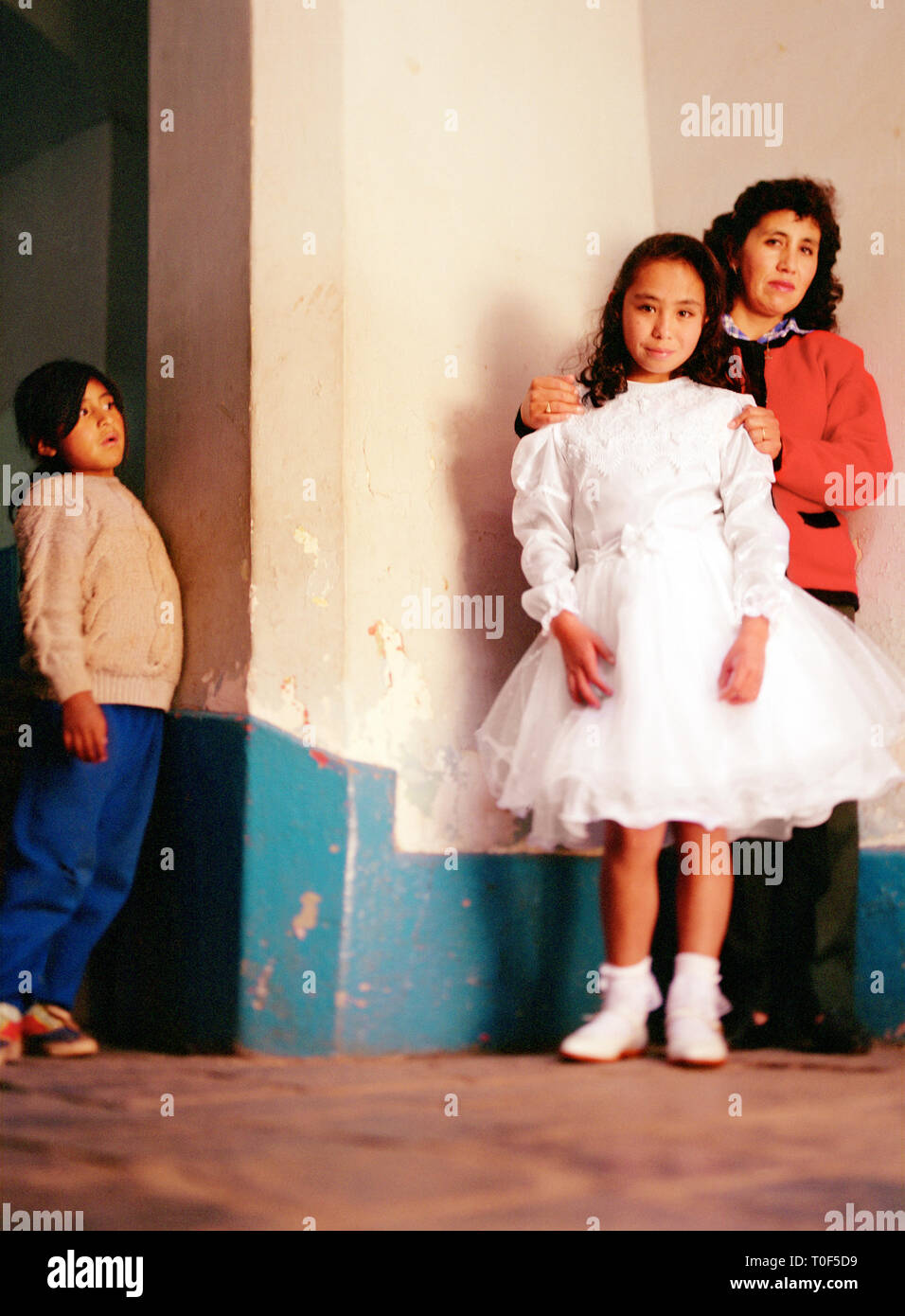 Peruvian girl in white dress with mother Stock Photo