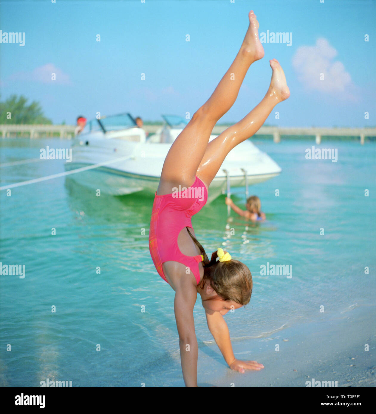 A girl is doing a handstand. Stock Photo