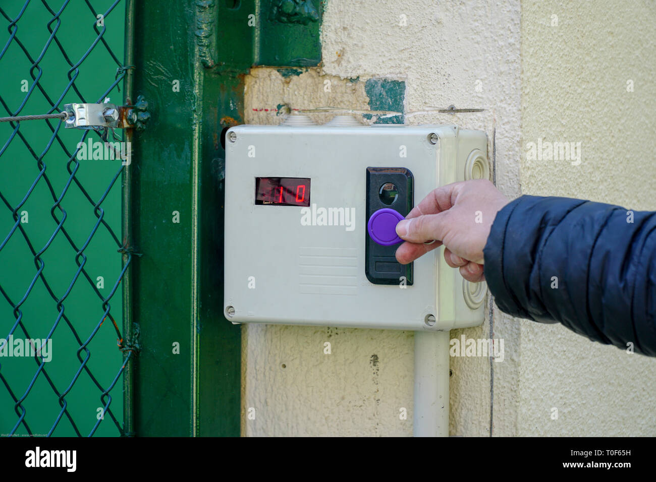 Door access control with a hand inserting key card to lock and unlock