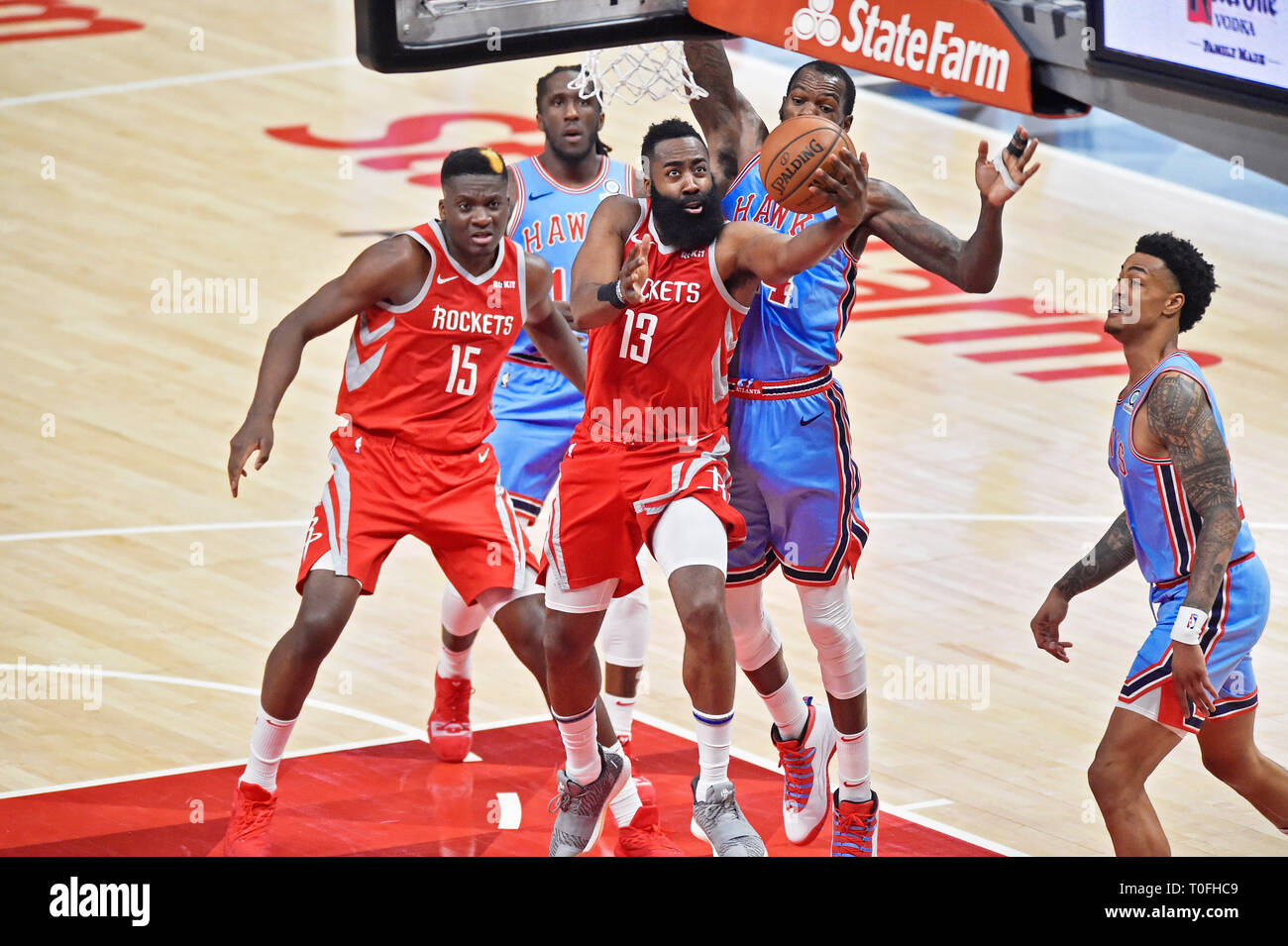 Atlanta GA USA. 20th Mar 2019. Houston Rockets guard James Harden 13 attempts a shot under the basket past an Atlanta Hawks defender during the third quarter of a NBA basketball game