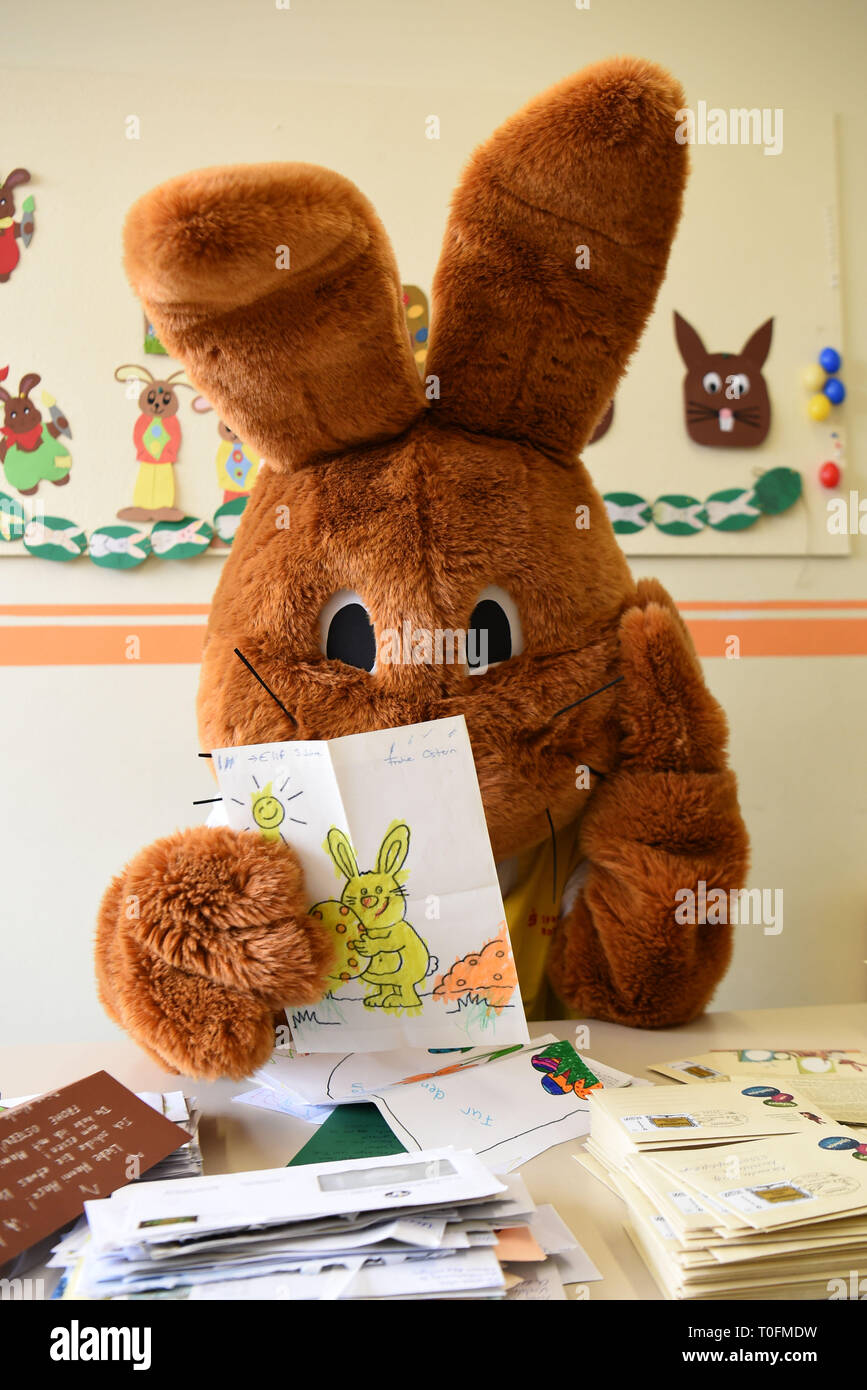 Zeven, Germany. 20th Mar, 2019. A giant stuffed animal called Hanni Hase  sits symbolically in the post office and reads a letter to Hanni Hase. The  letters that children from all over