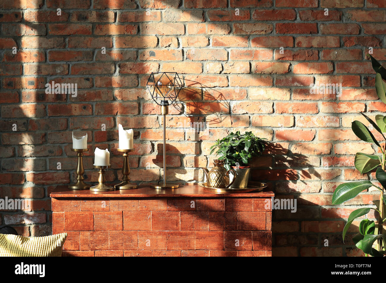 Interior. Sunny day in a room with brick wall Stock Photo - Alamy