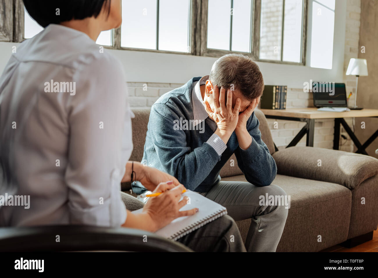 Desperate adult man being in panic with his mental issues Stock Photo