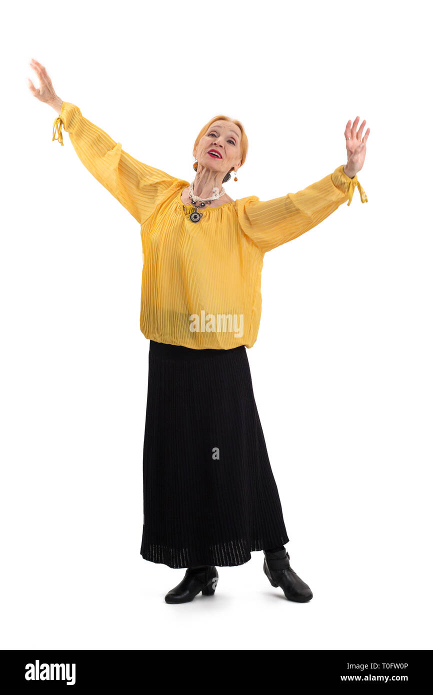 Elderly woman dancing. Lady with outstretched arms isolated. Stock Photo
