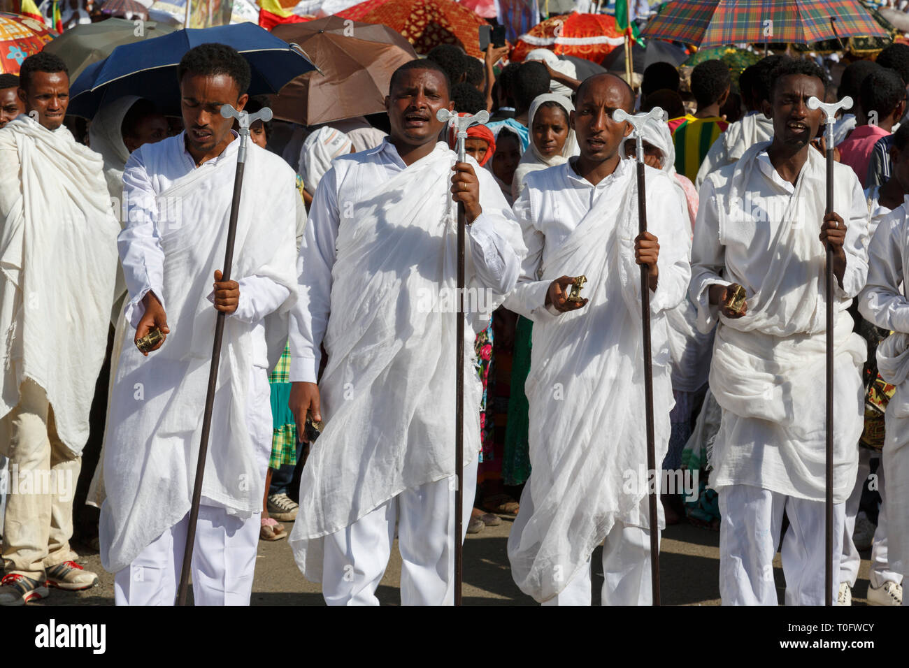 Gonder, Ethiopia, February 18 2015: Men dressed in traditional attire with pilgrim rod celebrate the Timkat festival, the important Ethiopian Orthodox Stock Photo