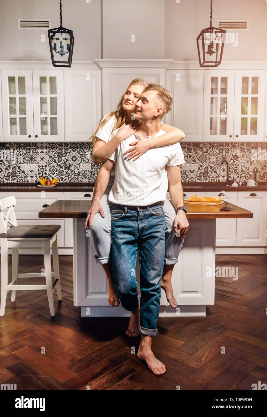 Lovely couple are hugging and smiling while spending time together ...