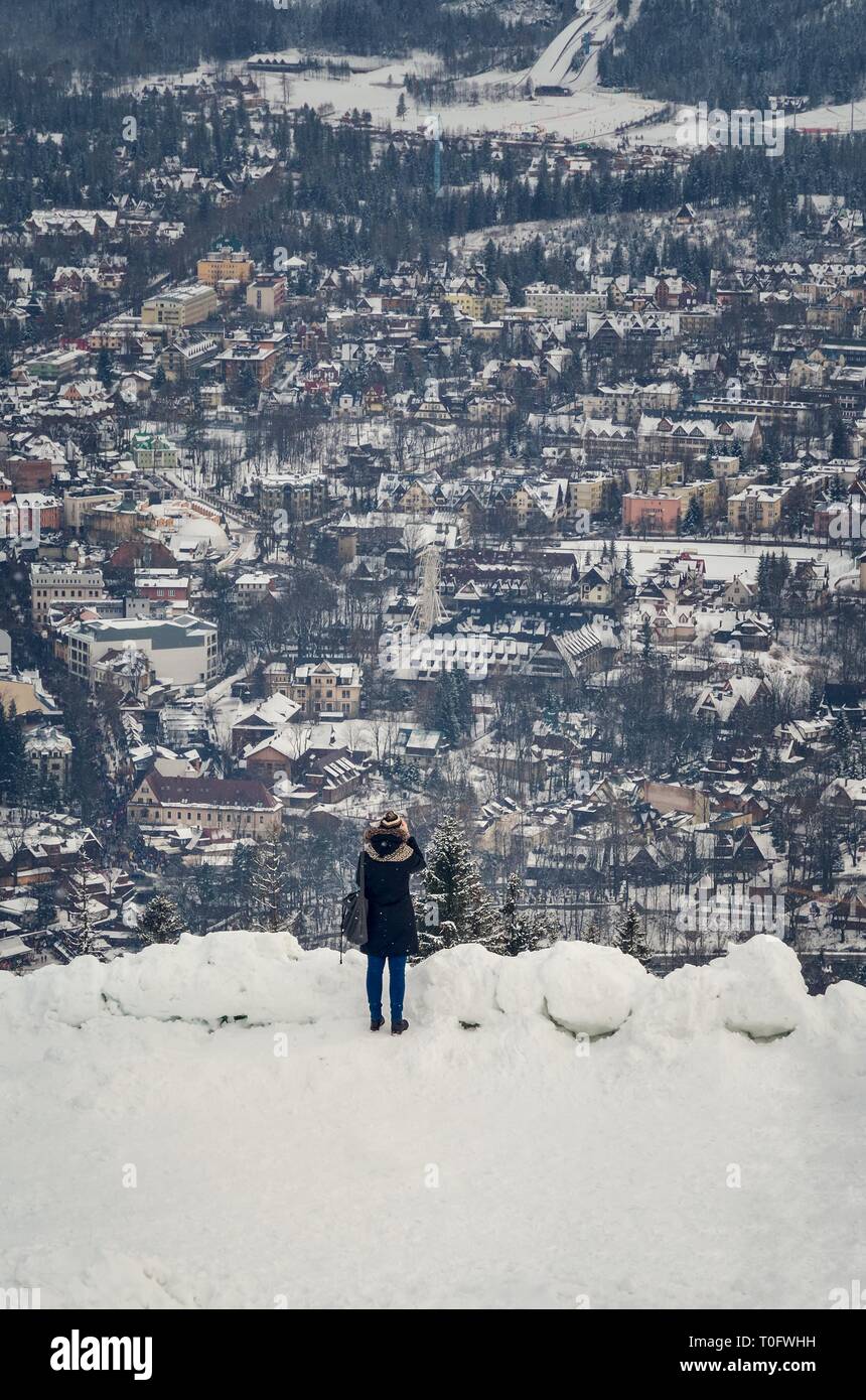 ZAKOPANE, POLAND - DECEMBER 30, 2018: Tourist taking pictures of the city from the Gubalowka peak in Zakopane, Poland. Stock Photo