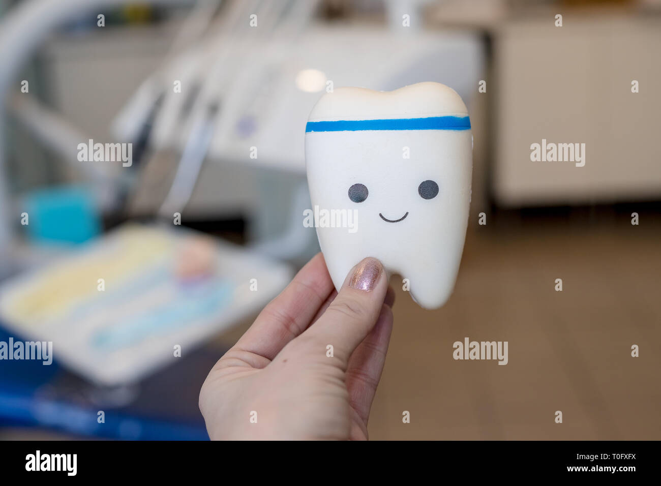 Toy model of tooth with cute face.orthodontic model and dentist tool