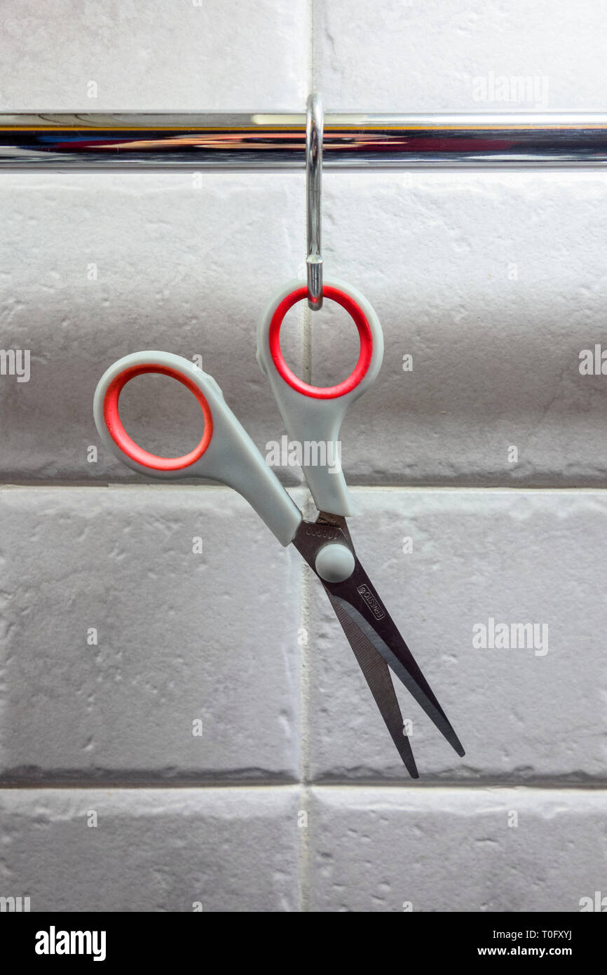 scissors hanging up in a kitchen Stock Photo