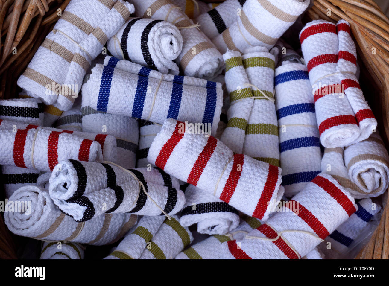 https://c8.alamy.com/comp/T0FY0D/rolled-striped-tea-towels-or-dishtowels-in-a-basket-T0FY0D.jpg