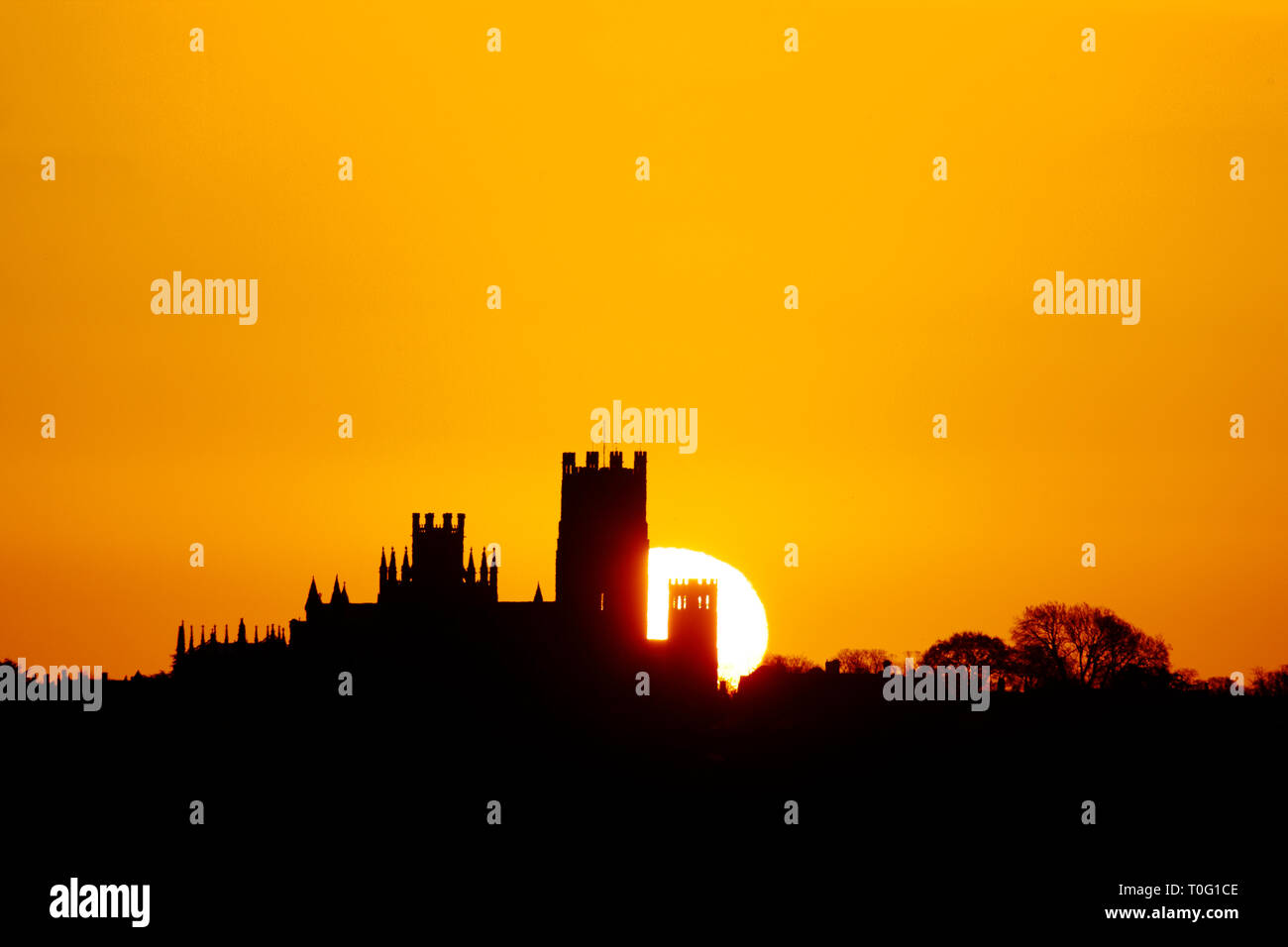 Sunrise behind Ely Catheral from Little Downham using a 600mm lens for perspective compression. Stock Photo