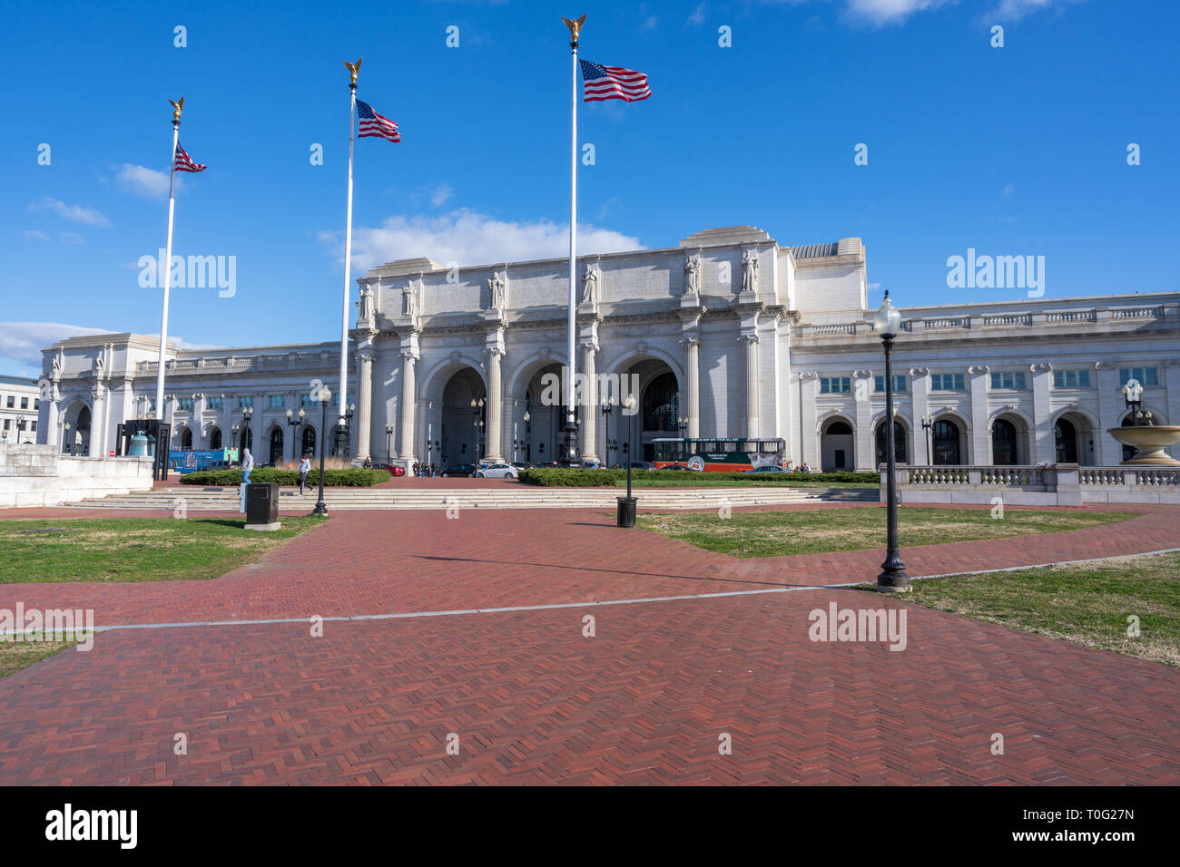 Washington, DC, USA --  March 16, 2019. Three American flags fly in the wind outside of Union Station in Washington, DC. Stock Photo