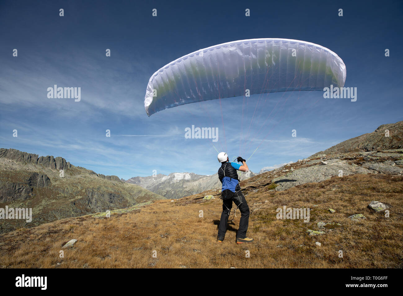 Young paraglider pilot uses his paraglider to play with the wind in the