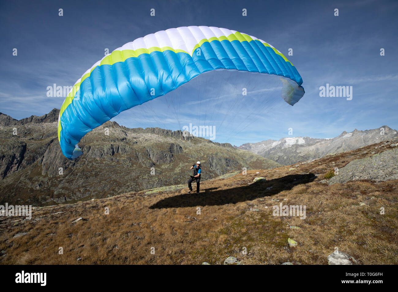 Young paraglider pilot uses his paraglider to play with the wind in the