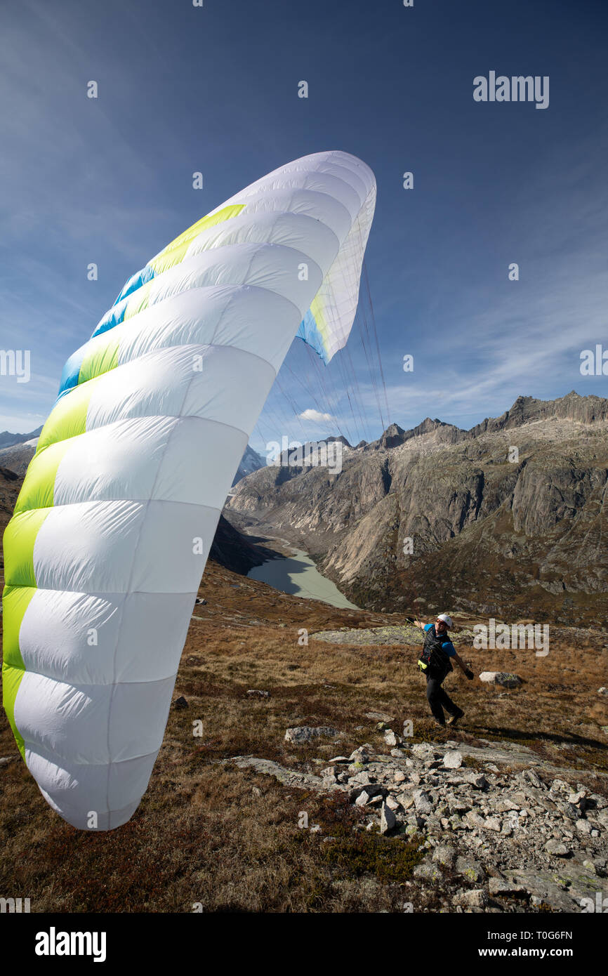 Young paraglider pilot uses his paraglider to play with the wind in the