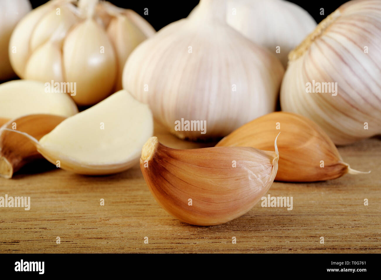 Garlic cloves on wooden vintage background Stock Photo - Alamy