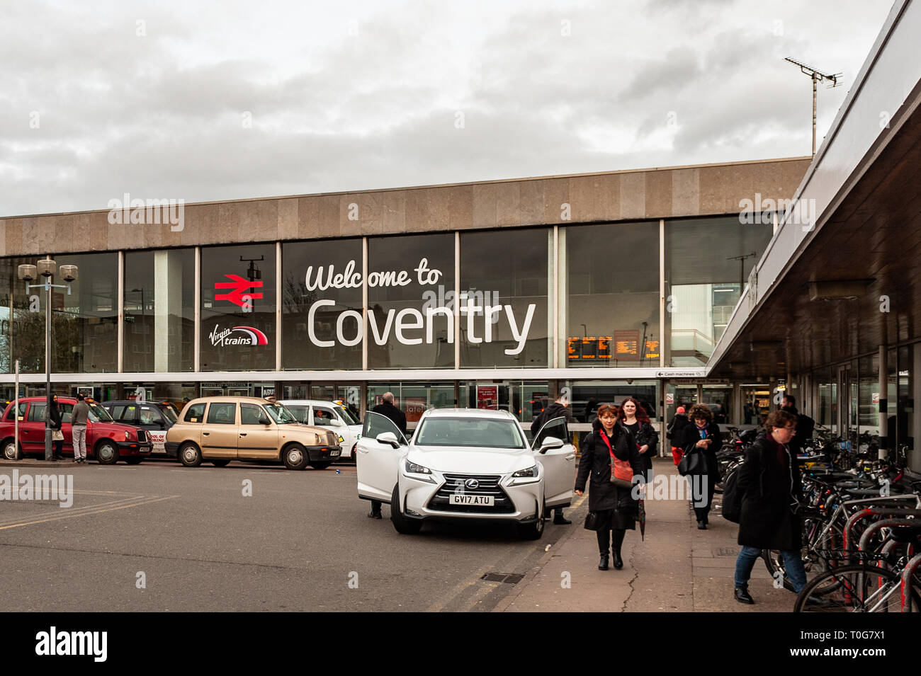 Taxis and commuters outside Coventry Railway Station, Coventry, West Midlands, UK. Stock Photo
