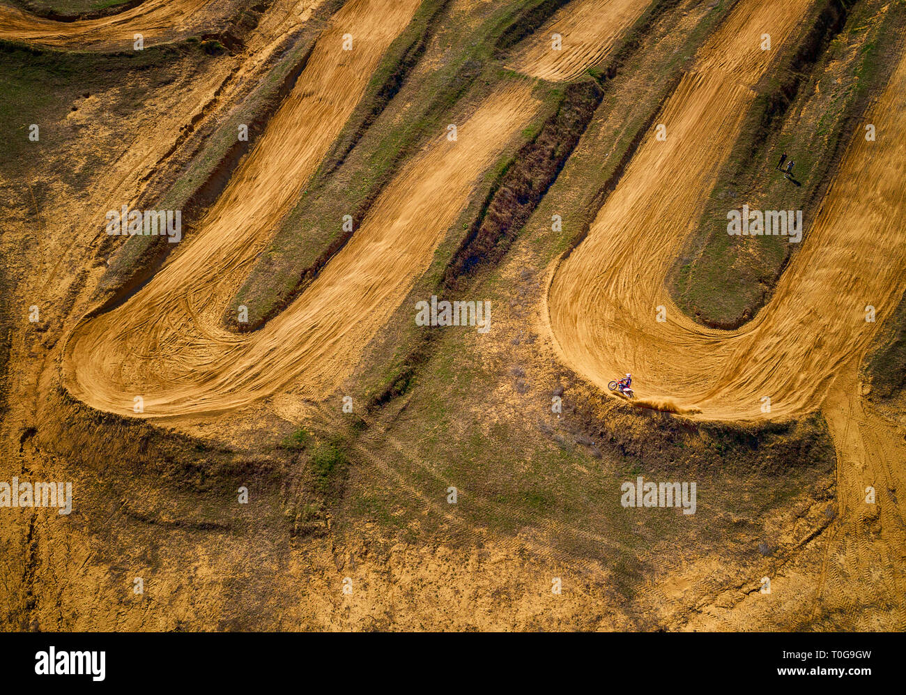 Aerial view of racing motocross bikes in racetrack. Outdoor motor sport from drone view. - Image Stock Photo