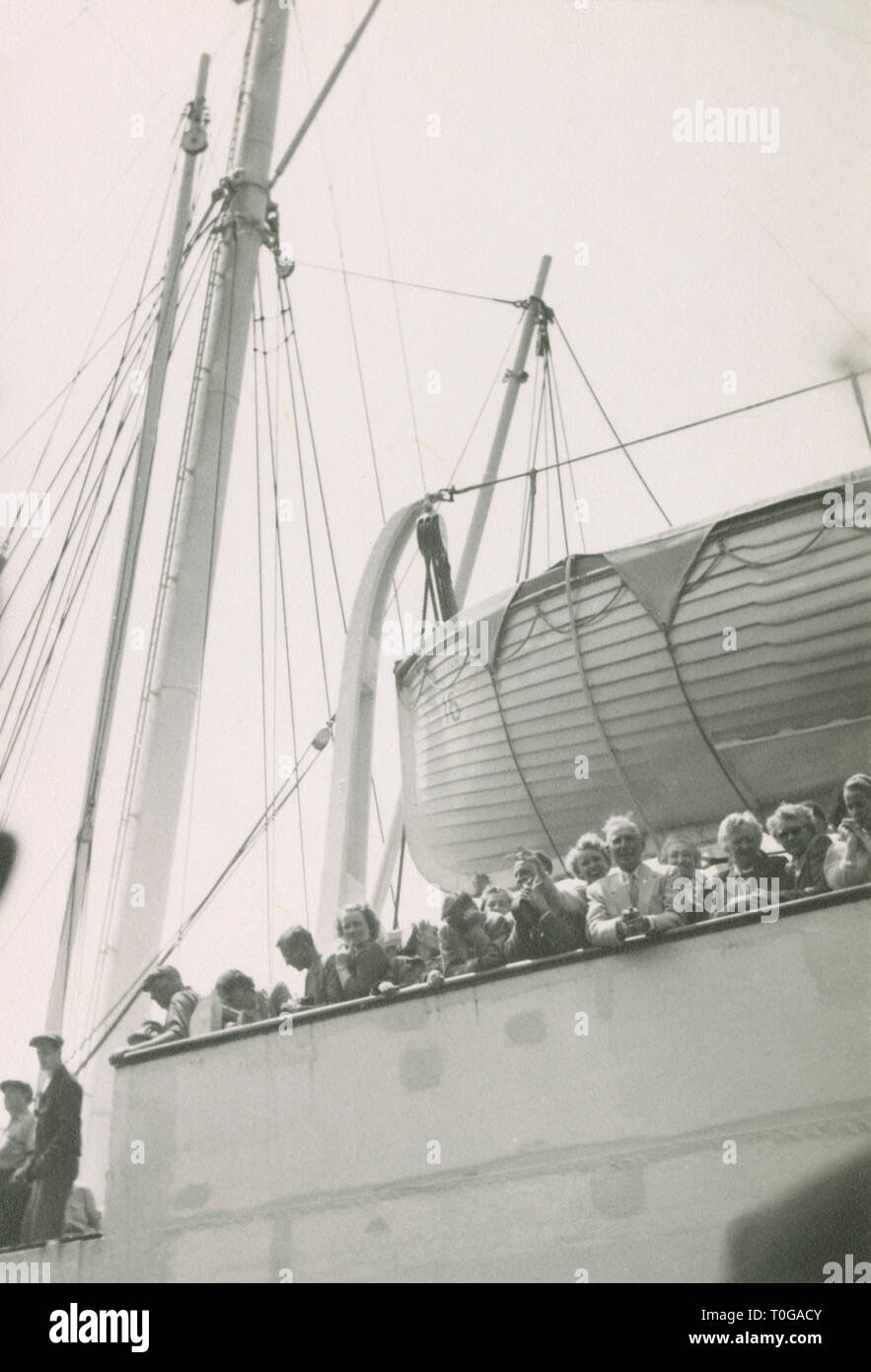 Antique c1930 photograph, travelers at the rail of an arriving steamship. Location unknown, USA. SOURCE: ORIGINAL PHOTOGRAPH. Stock Photo