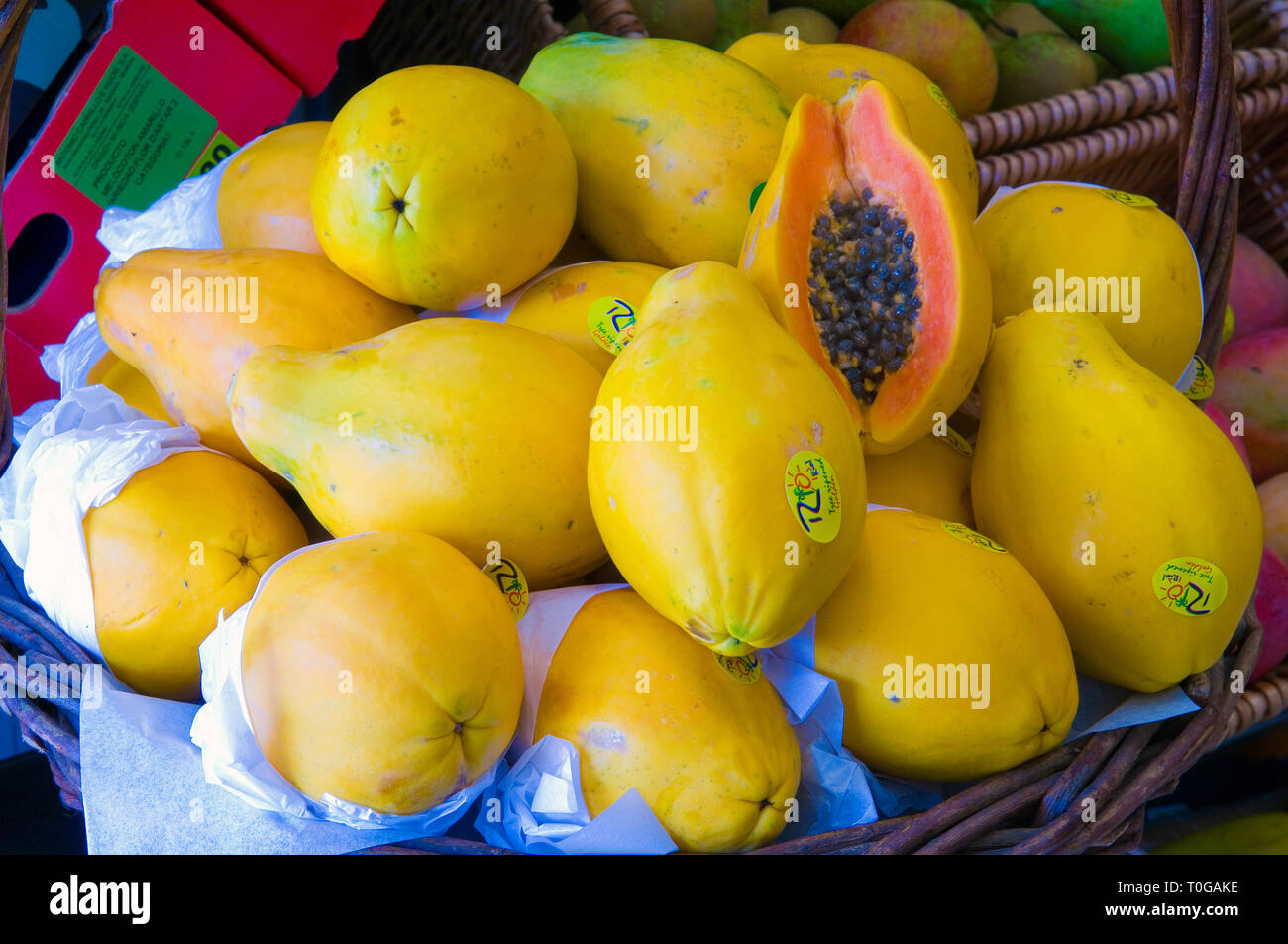 Papaya in a basket for sale in a green grocers. Stock Photo
