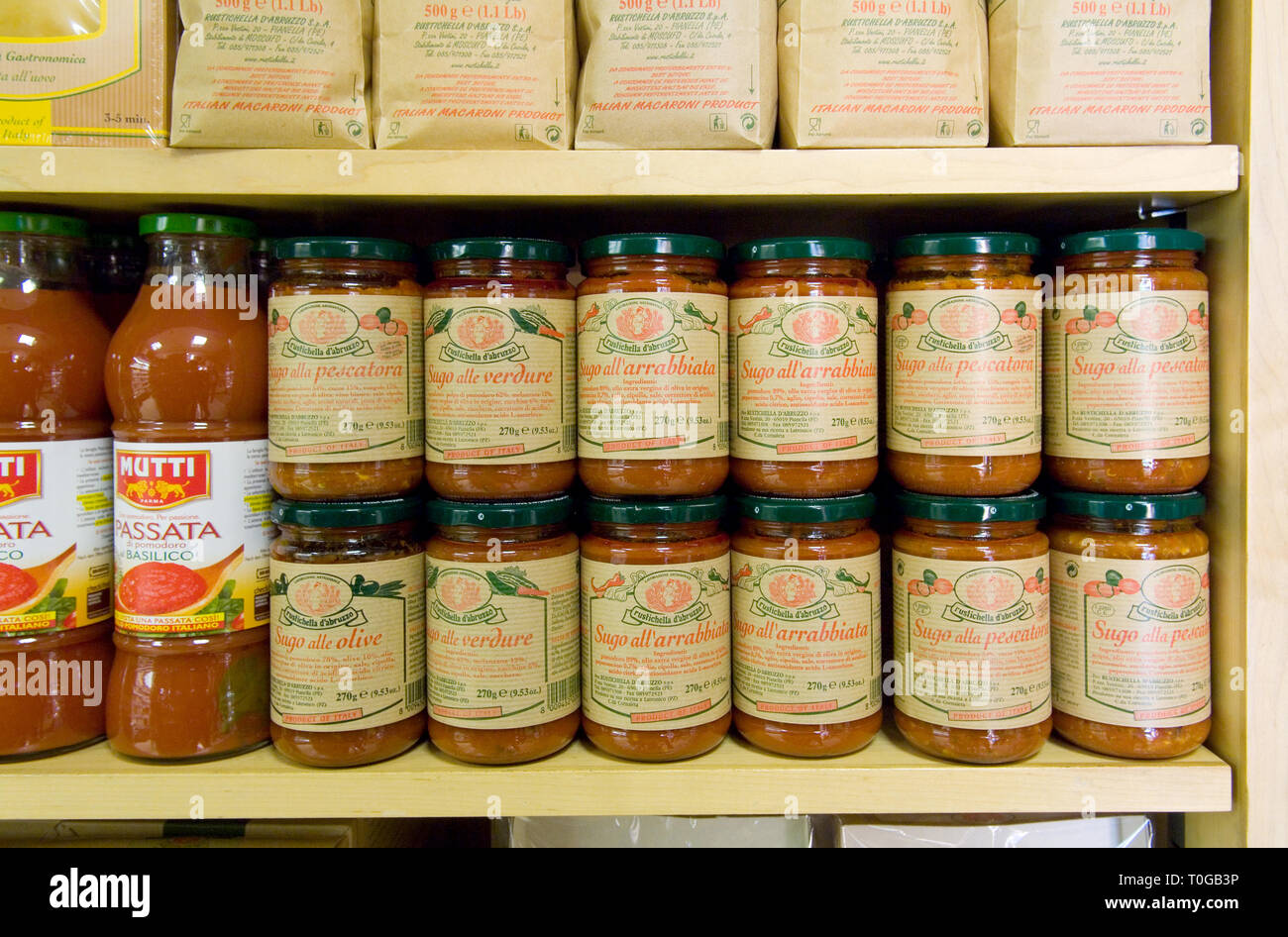 Displays of various pasta and jars of pasta sauce on display in a specialist shop. Stock Photo