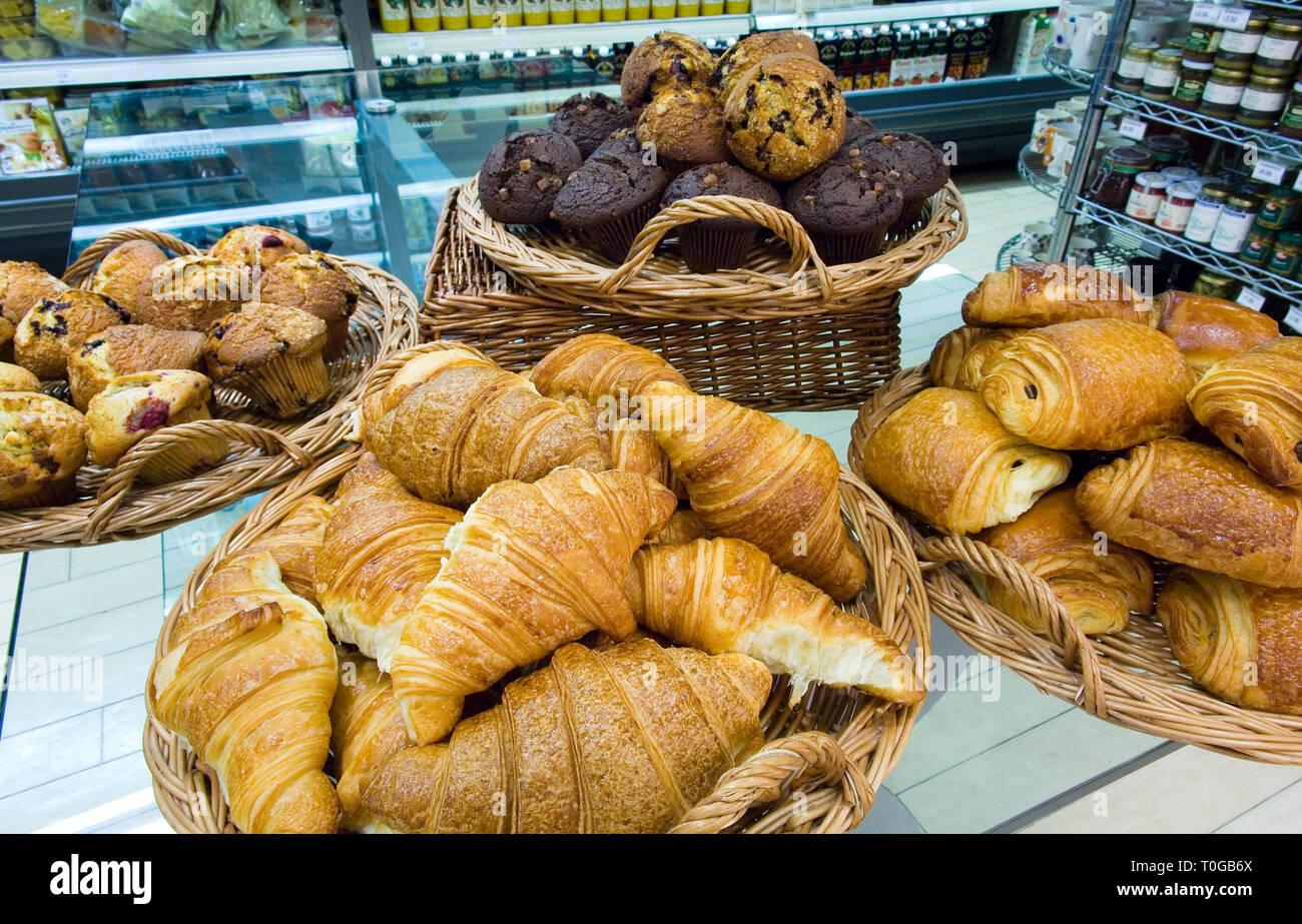 Crusty bread and croissants for sale in a deli. Stock Photo