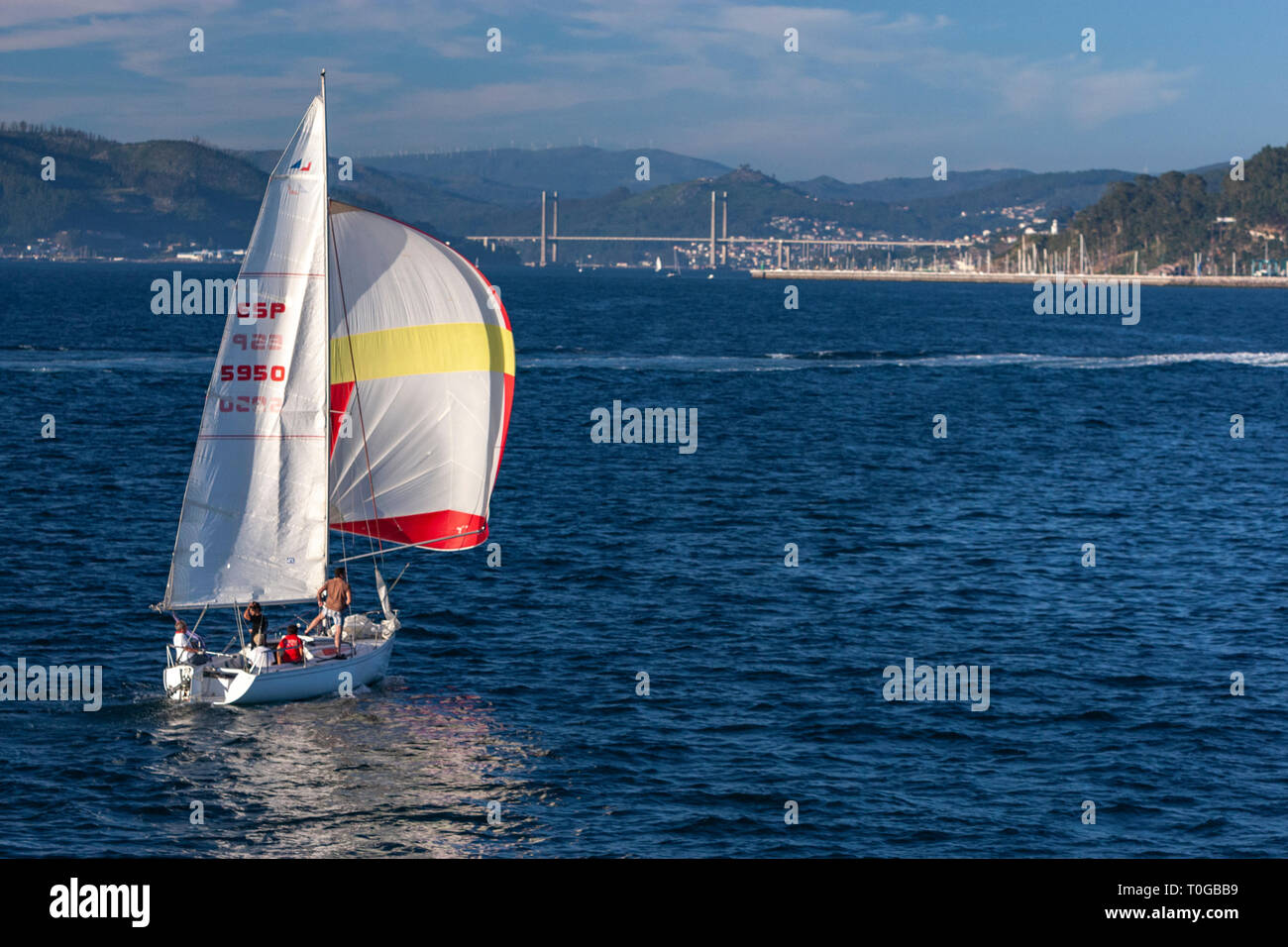 Sailing boat with the Rande Bridge at the background, Ria de Vigo, Spain Stock Photo