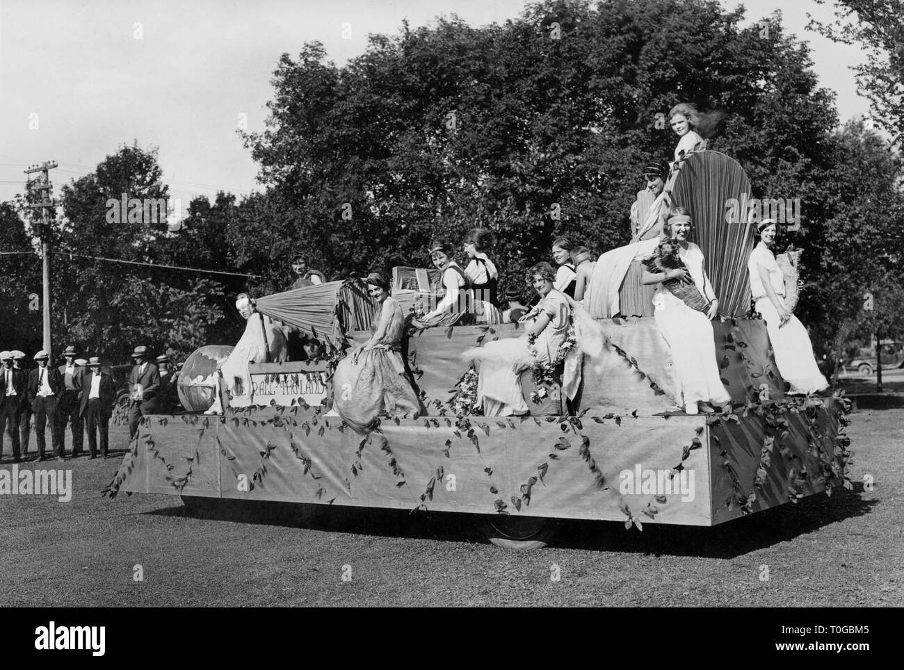 Young women pose atop a float after a Nebraska parade after winning the float contest, ca. 1925. Stock Photo