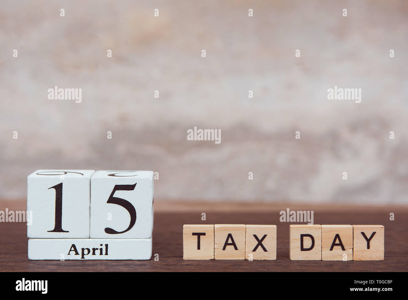Tax day with 15th April. Calendar and alphabet wooden block cube with ...