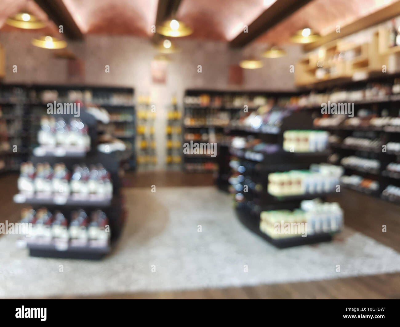 Liquor store blur background. Market shelf with wine bottles Stock Photo