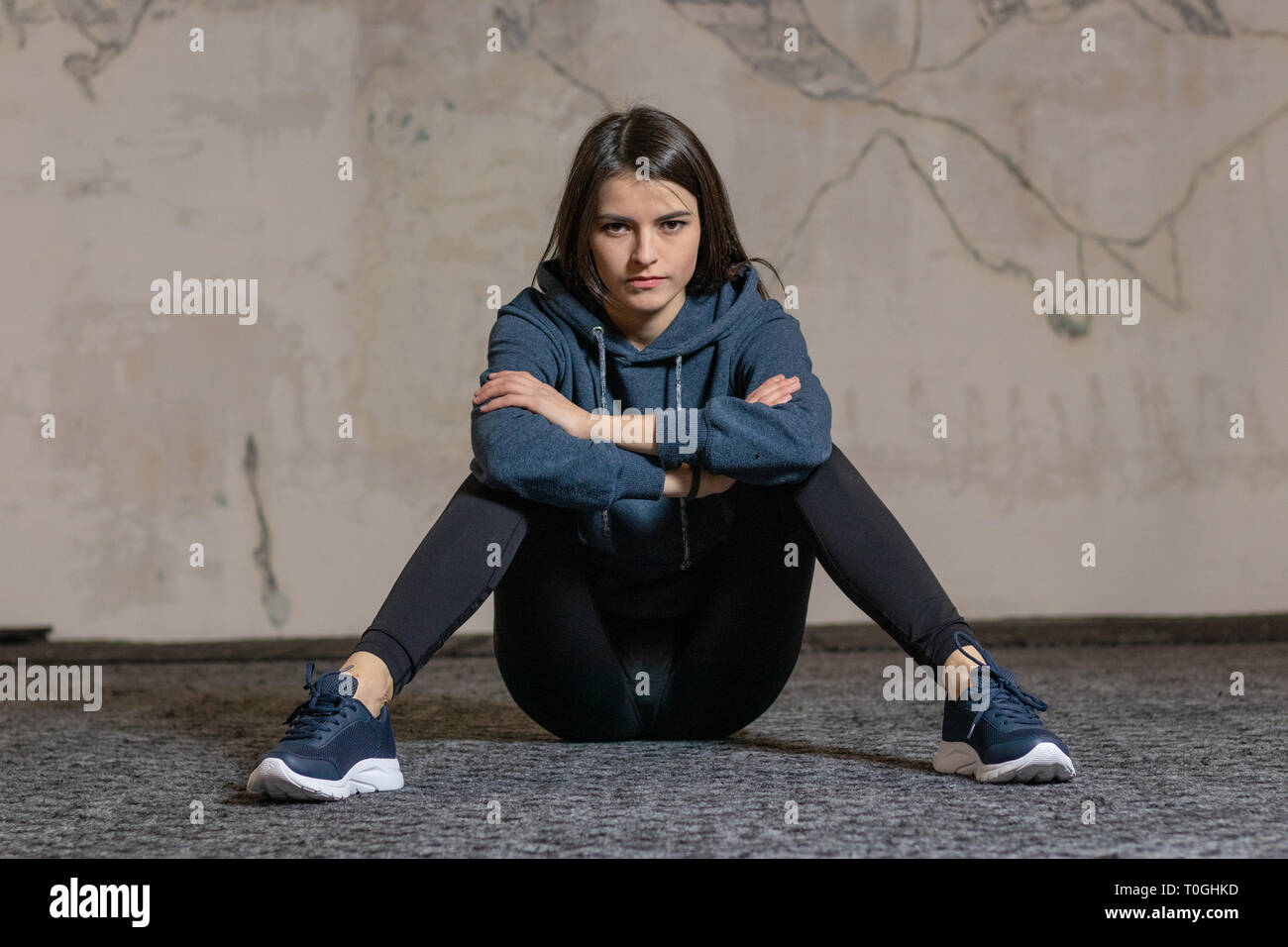 The girl sits on the floor in the gym Stock Photo - Alamy