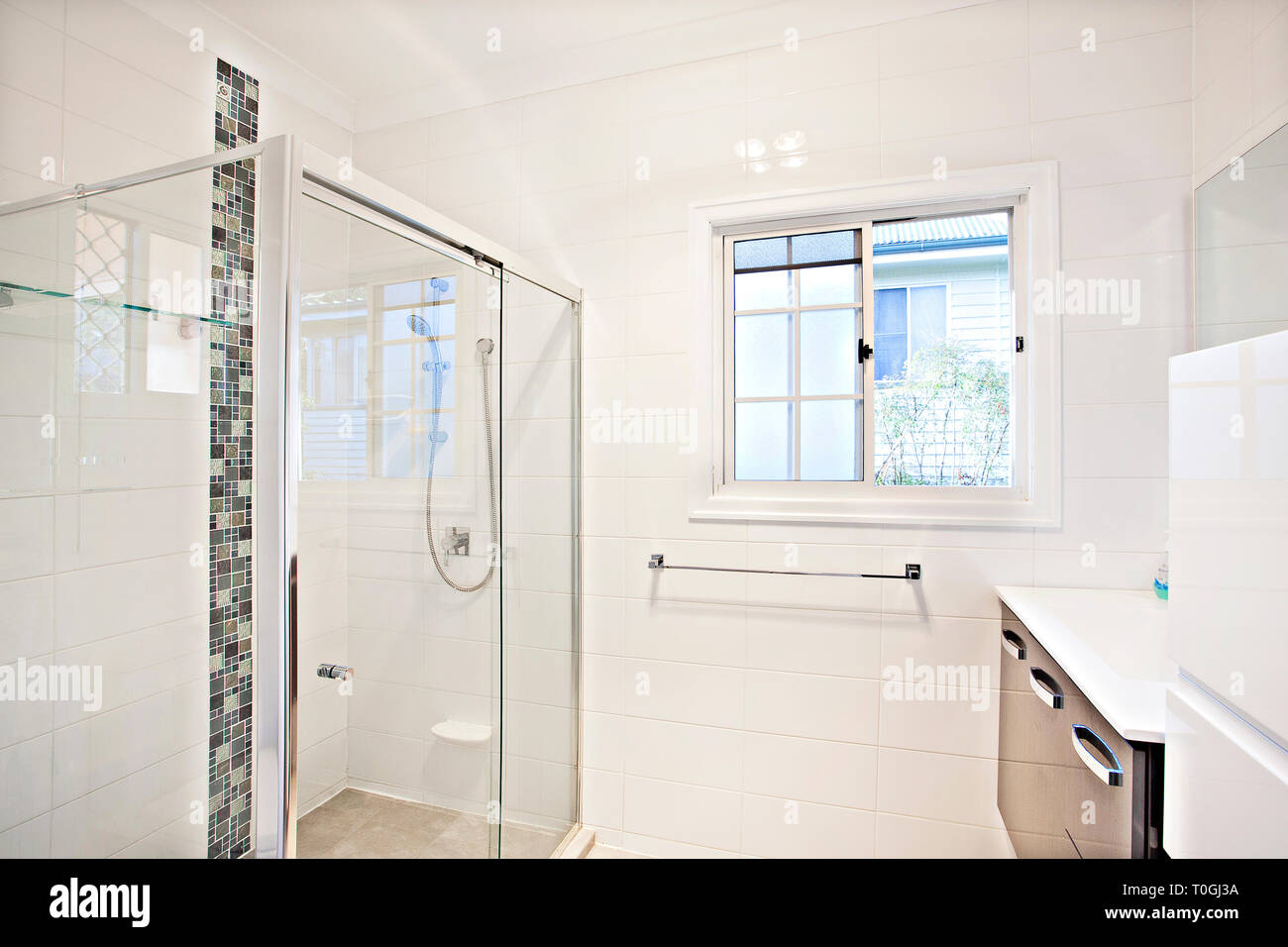 Modern White Bathroom Interior With Glass Shower Cubicle And