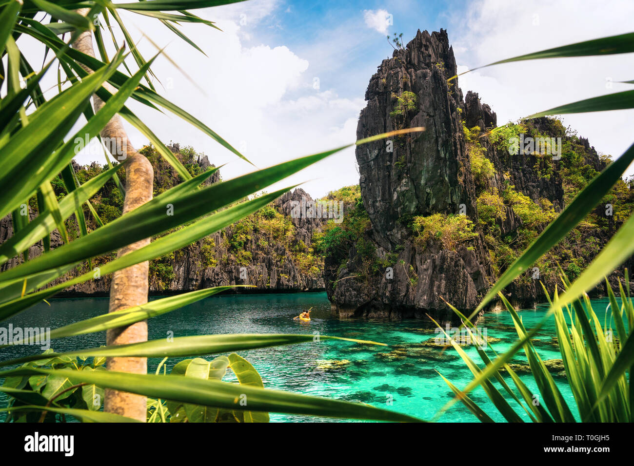 Kayak in the big lagoon with turquoise clean water among rocks and tropical forest, El Nido, Palawan, Philippines Stock Photo