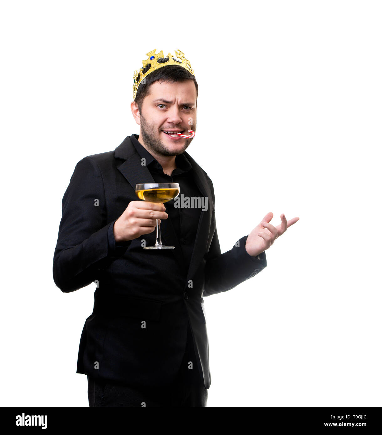 Happy man in crown, black suit with wine glass. Stock Photo
