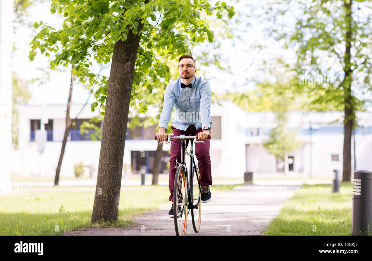 happy young hipster man riding fixed gear bike Stock Photo