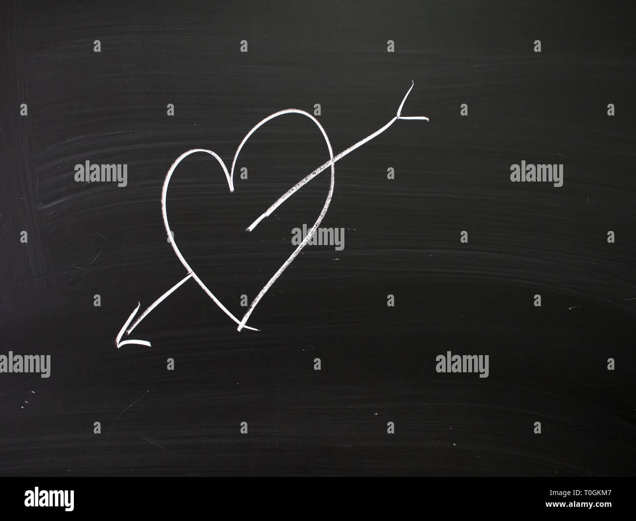 Real chalk heart on real school blackboard. Young love etc. Stock Photo