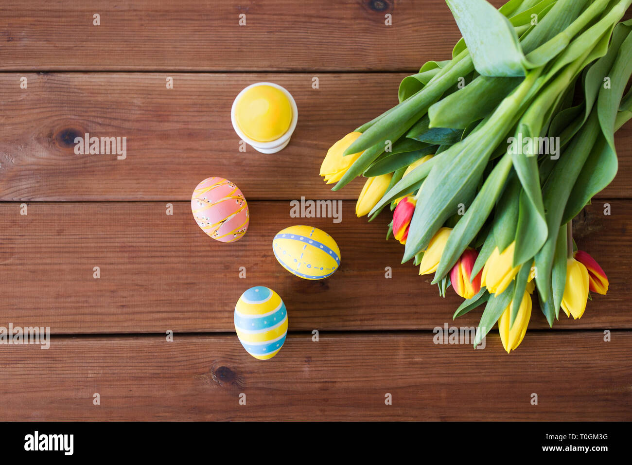 colored easter eggs and tulip flowers Stock Photo