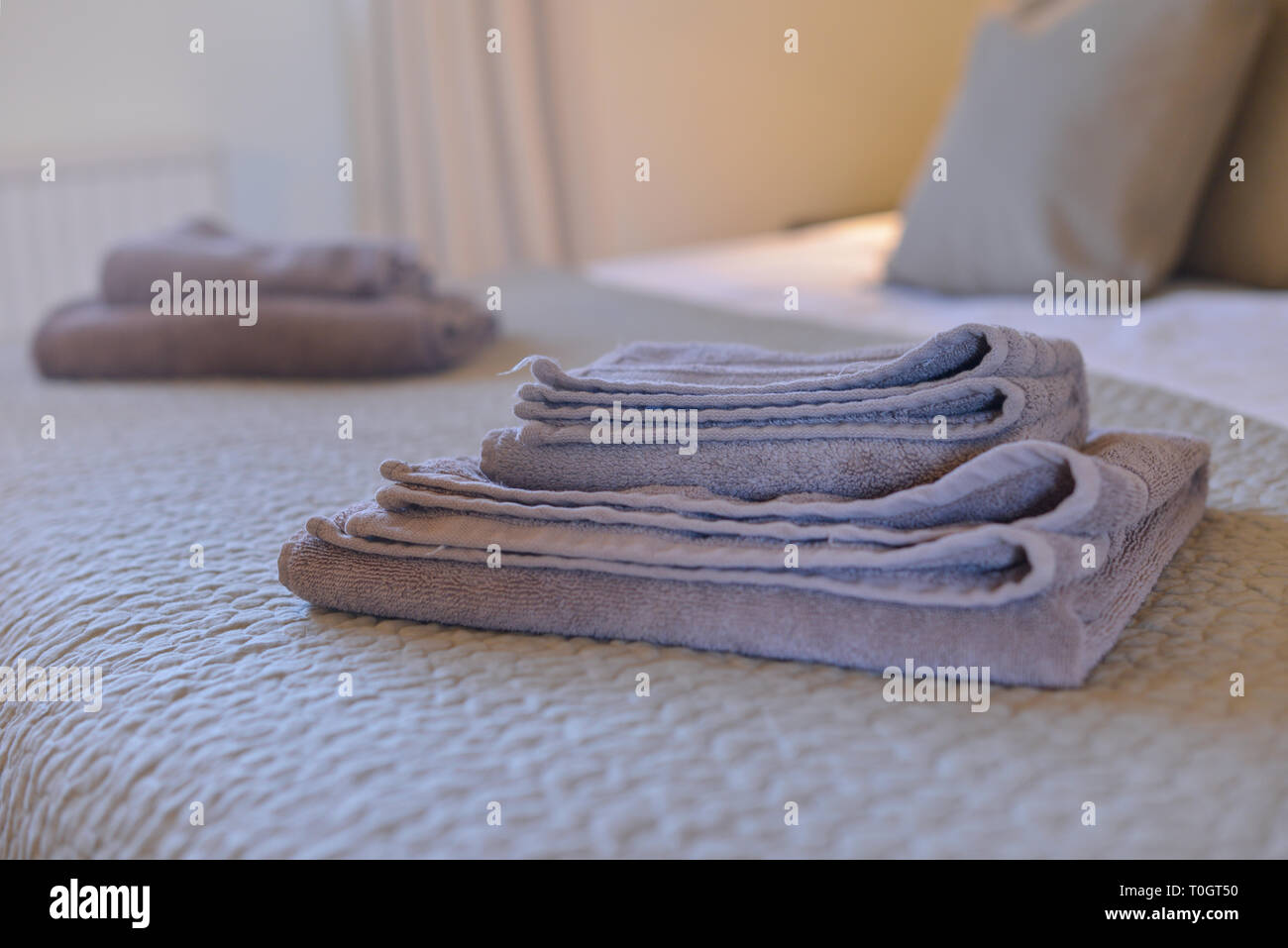 towels folded on a guest bed Stock Photo