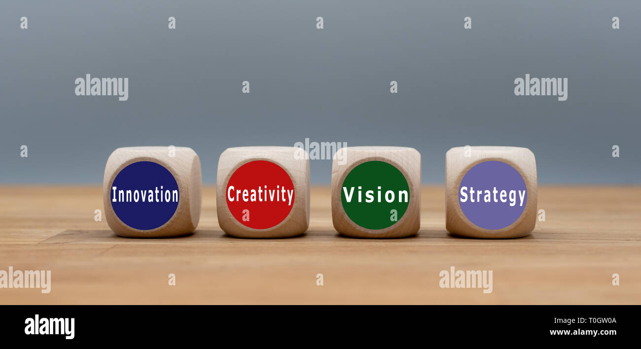 Four cubes with the text 'Innovation', 'Creativity', 'Vision' and 'Strategy' . Stock Photo