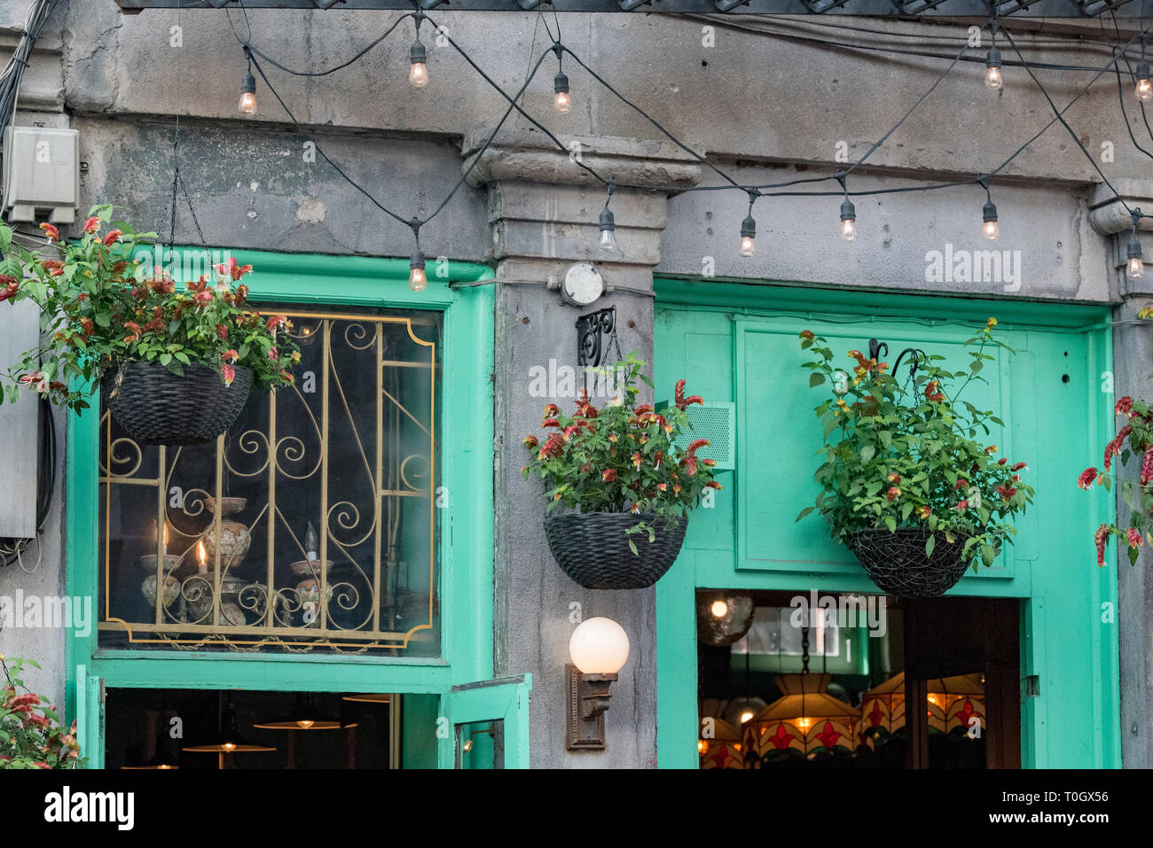 Old Montreal, Quebec, Canada. Hanging flower baskets above a concrete