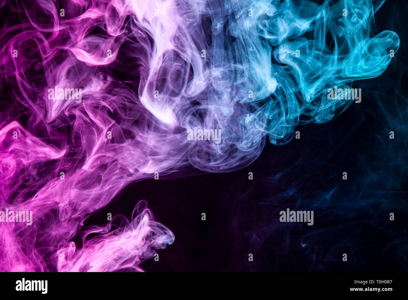 Frozen abstract movement of explosion pink and blue smoke multiple ...