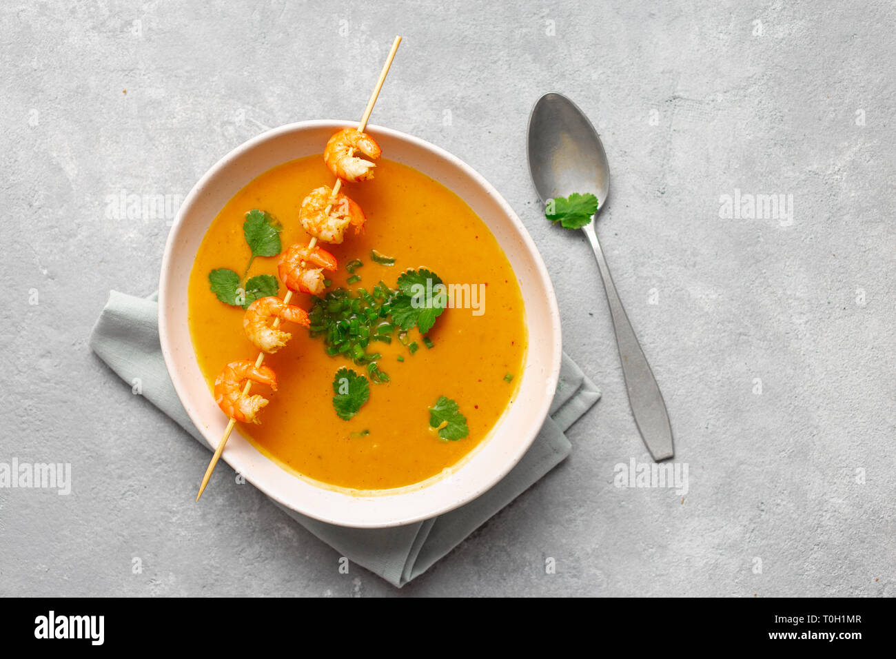 Bowl of sweet potato soup with shrimps top view Stock Photo
